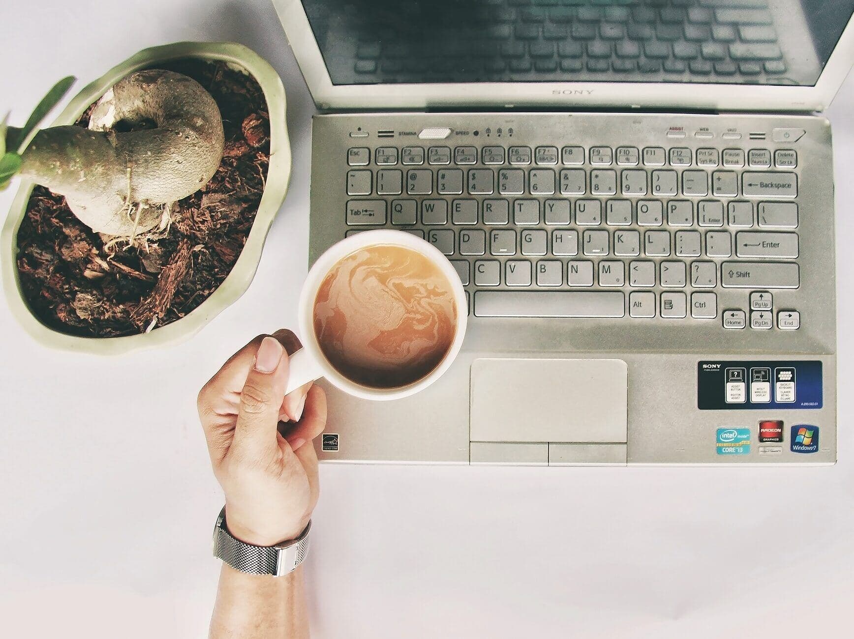 Morning coffee beside a laptop at the start of a posting window