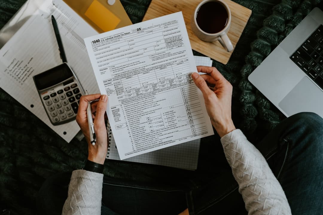 Working through revenue-per-session arithmetic with paperwork and a calculator