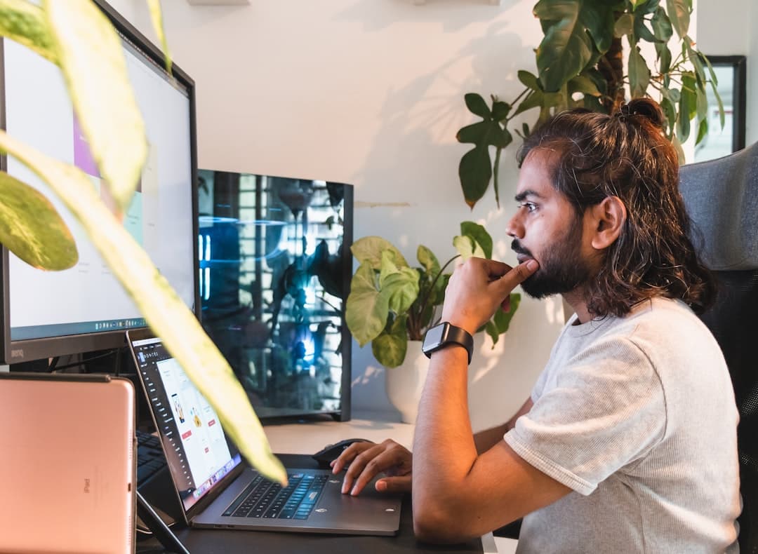 A freelancer working from a home desk, selling Pinterest work rather than traffic