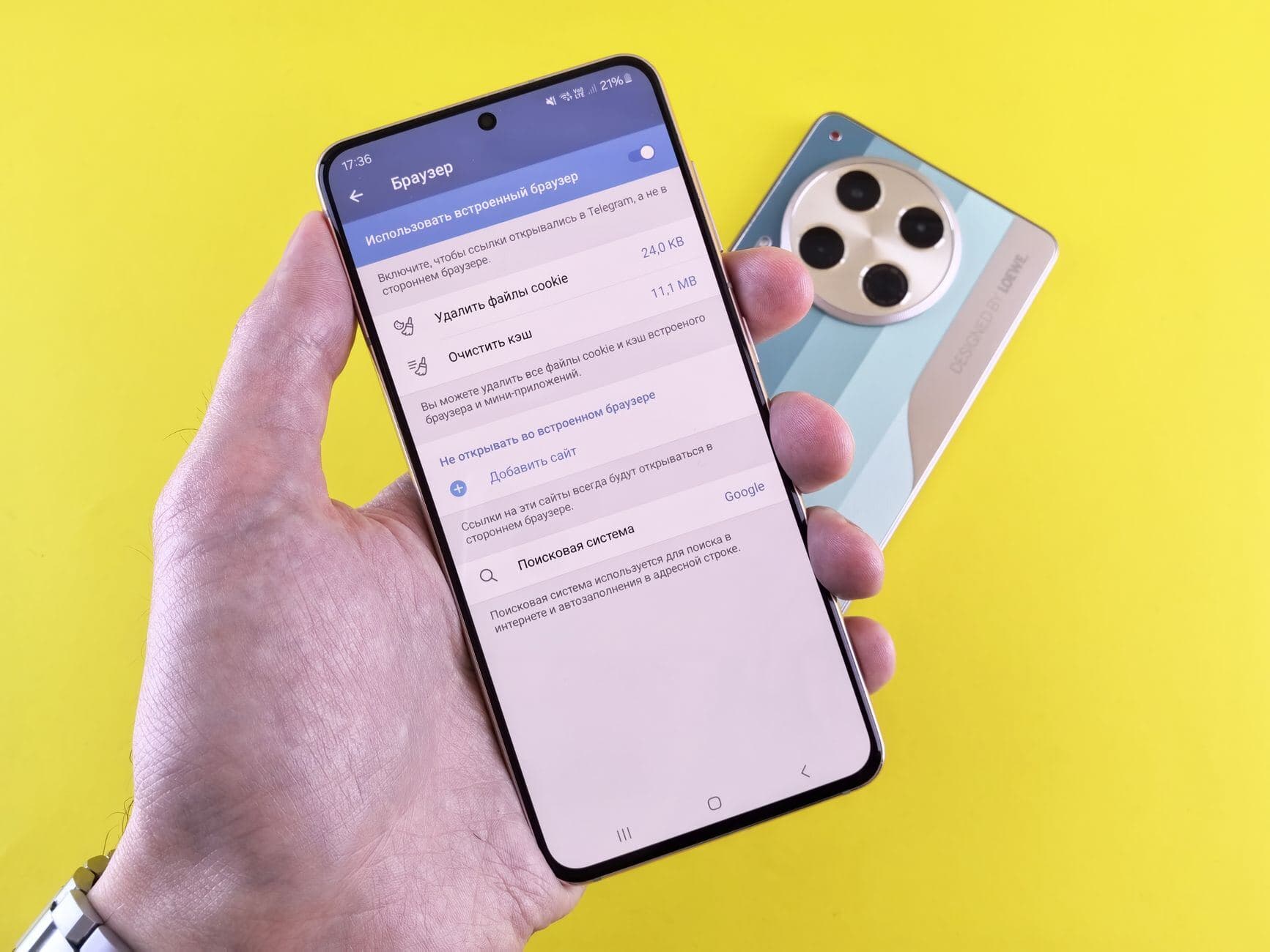 Smartphone settings screen held in hand