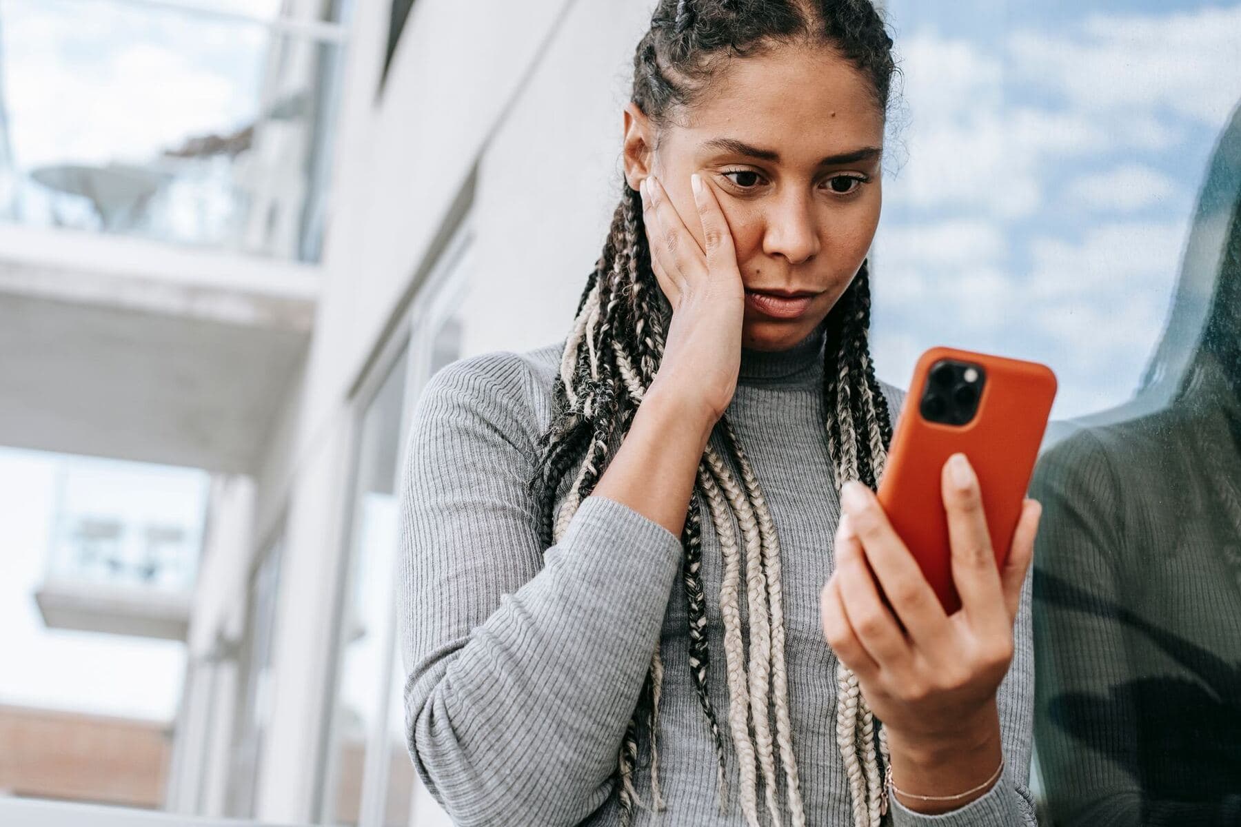 Person checking a phone with concern