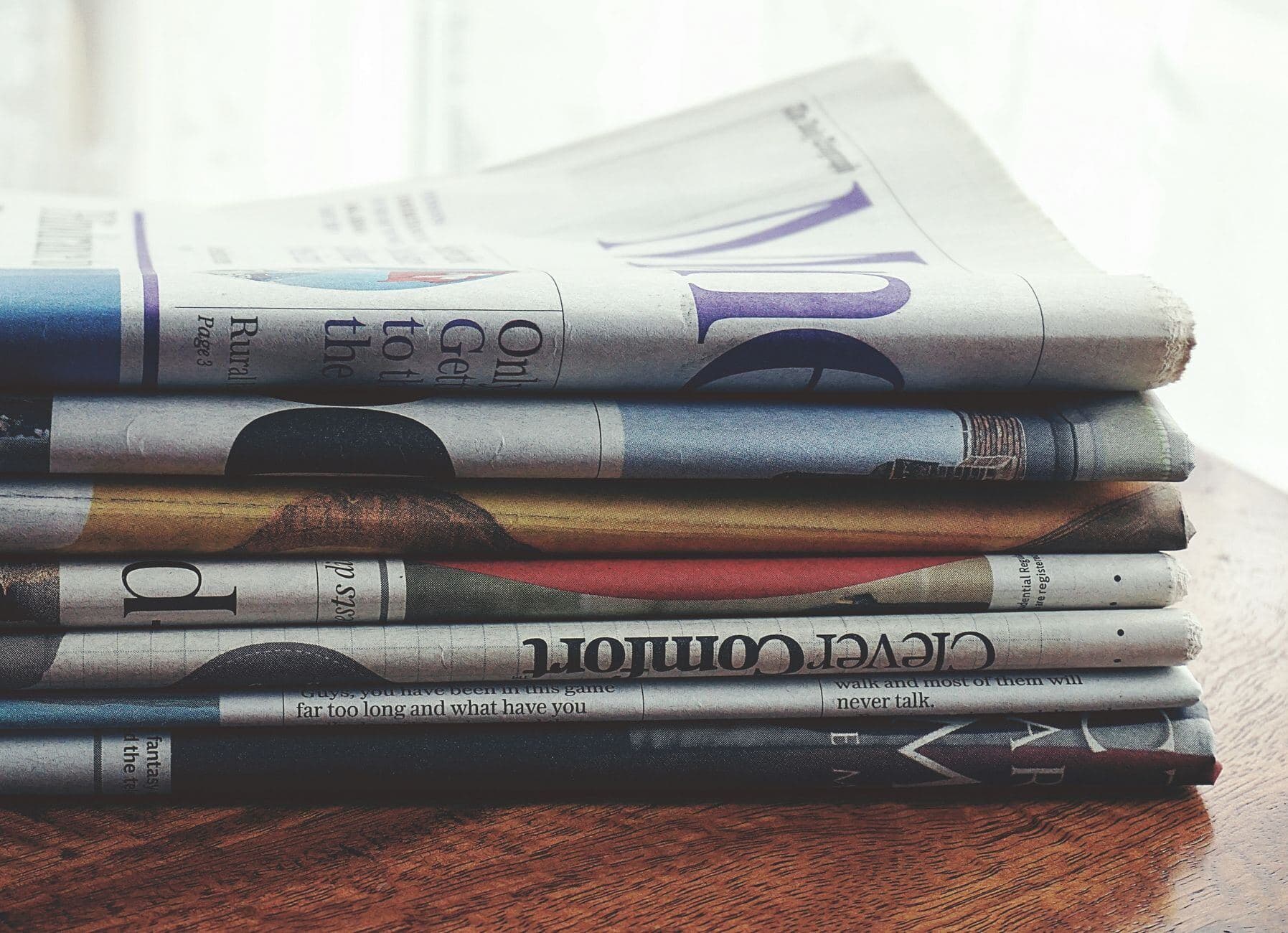 Newspaper headlines on a screen