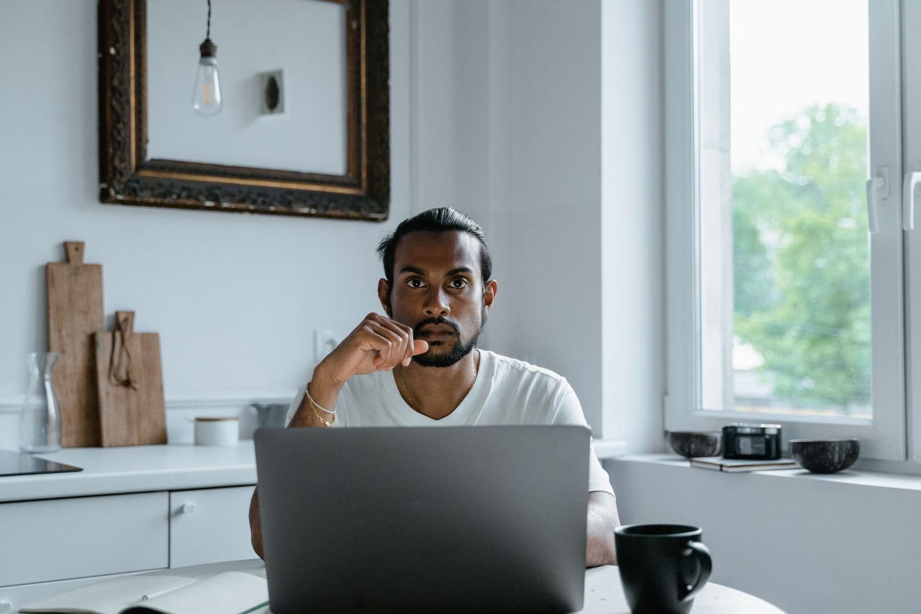 Person looking sceptically at a laptop