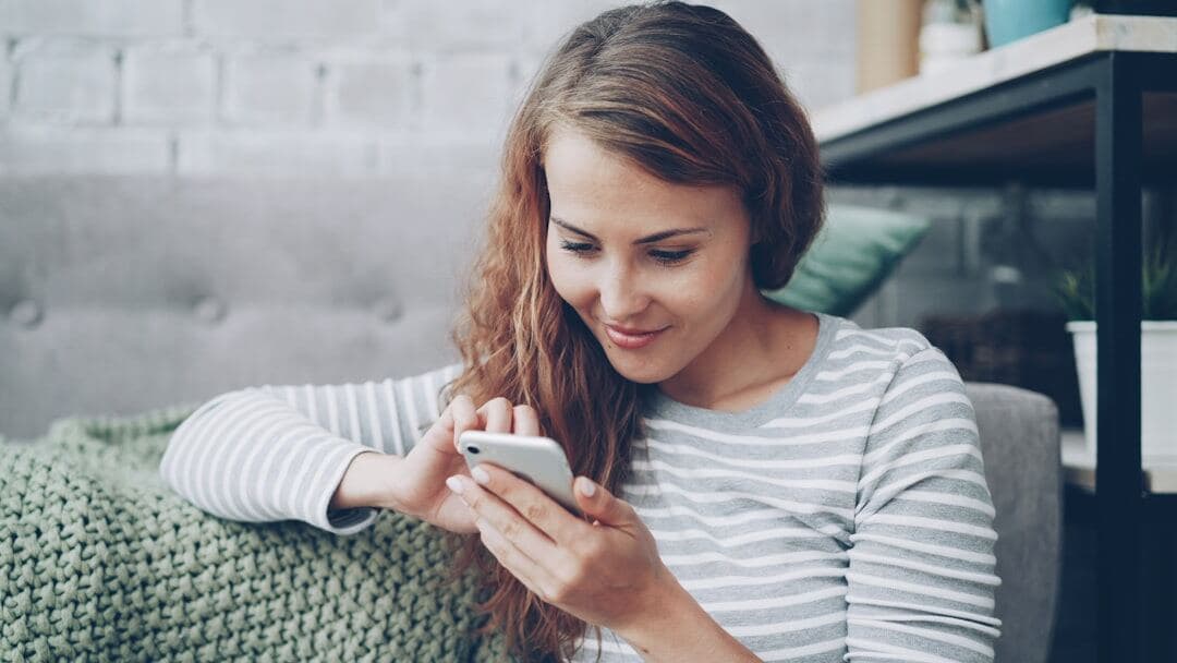 Woman scrolling a Pinterest feed on her phone
