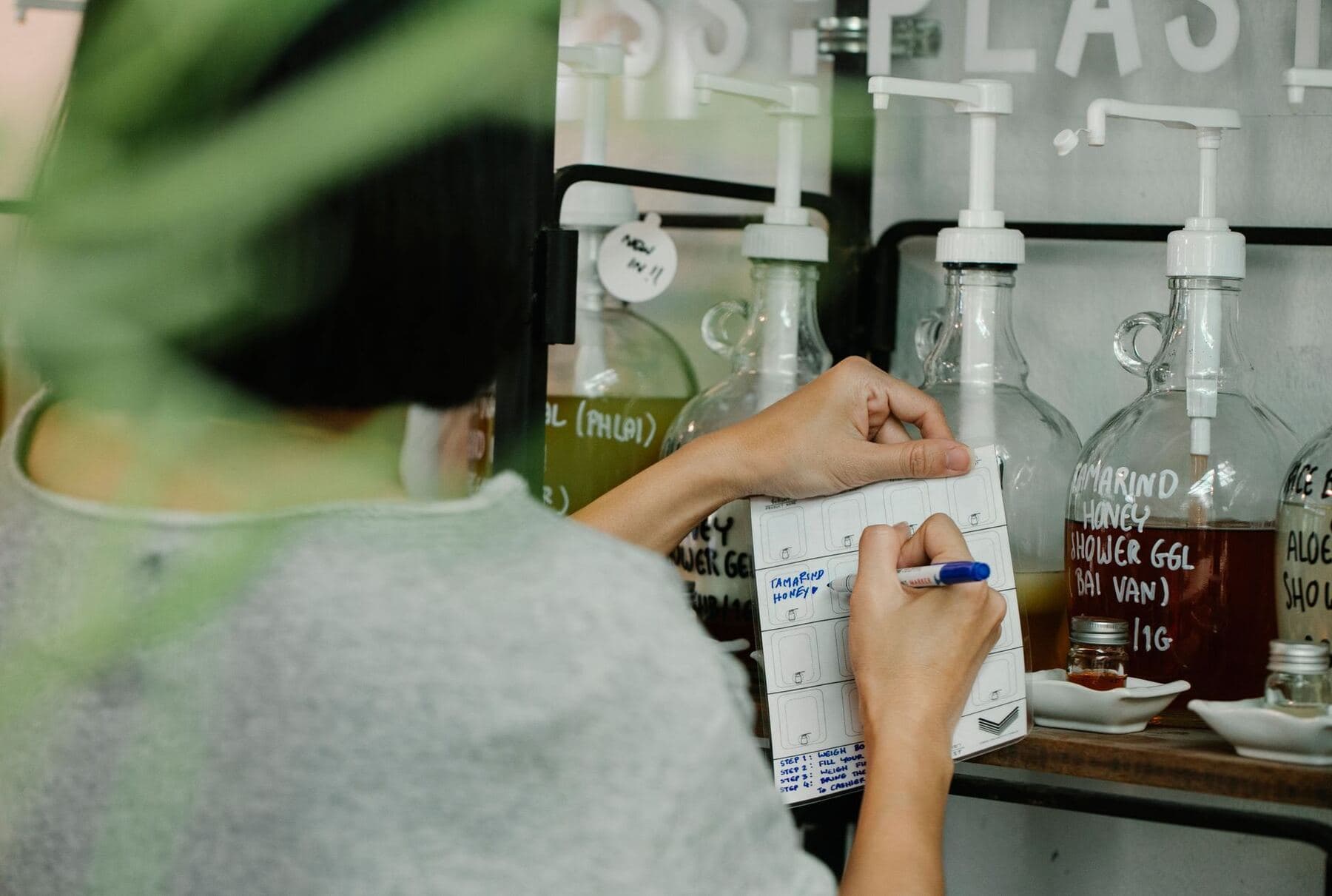 Person writing labels in a notebook