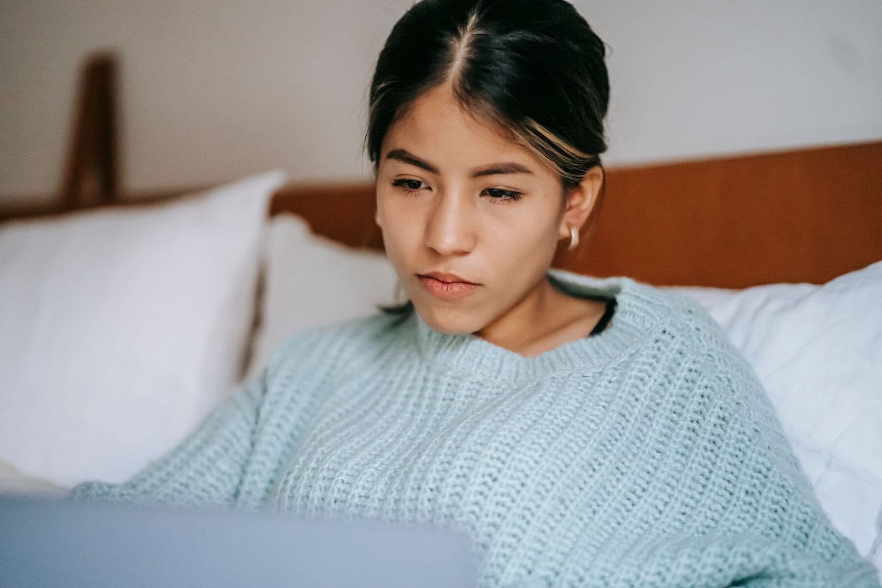 Woman comparing marketing tool options on a laptop
