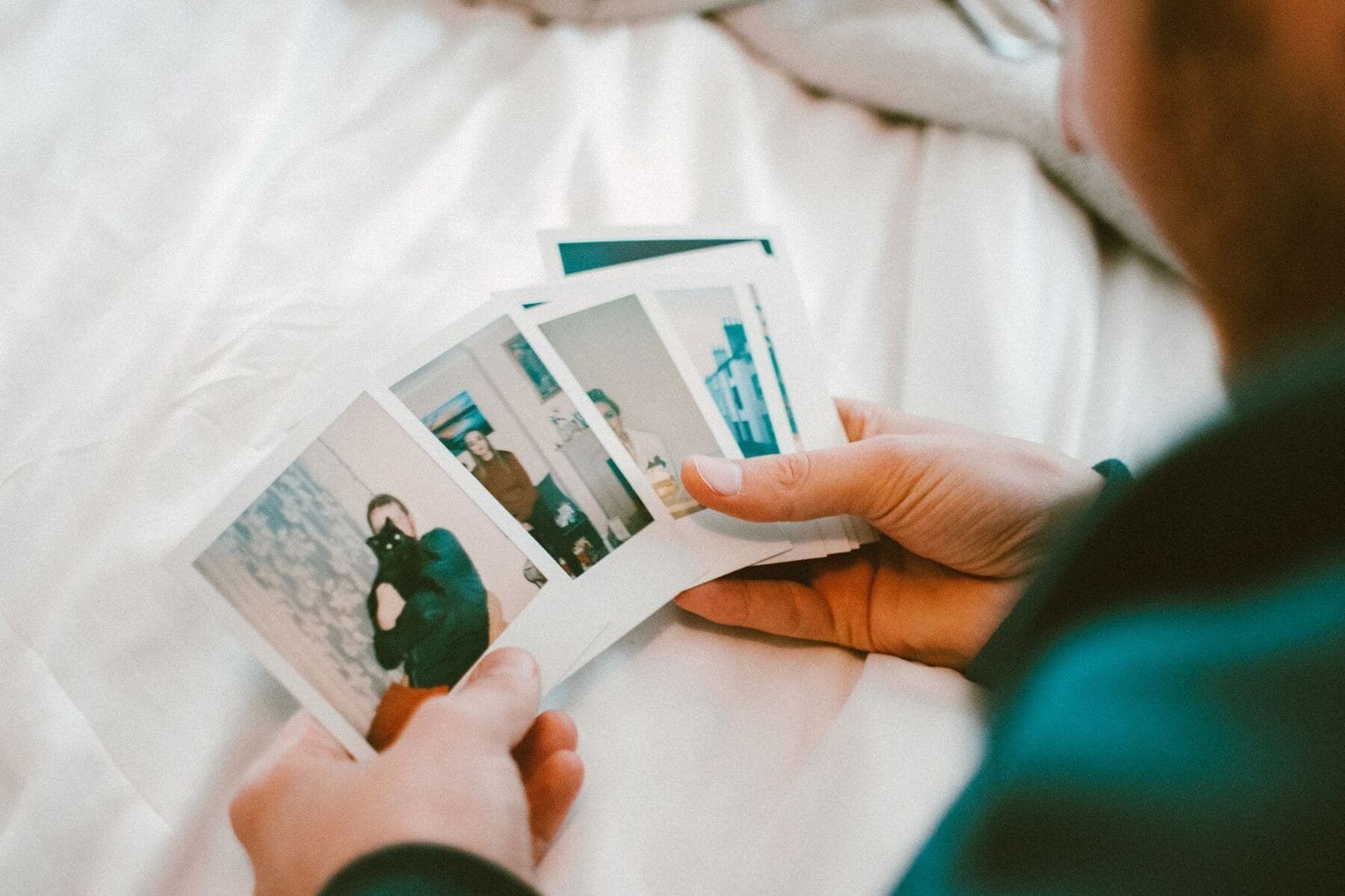 Hands rearranging photographs