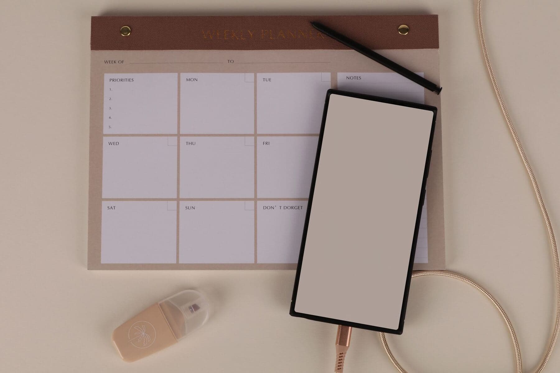 Calendar planner and phone laid out on a desk