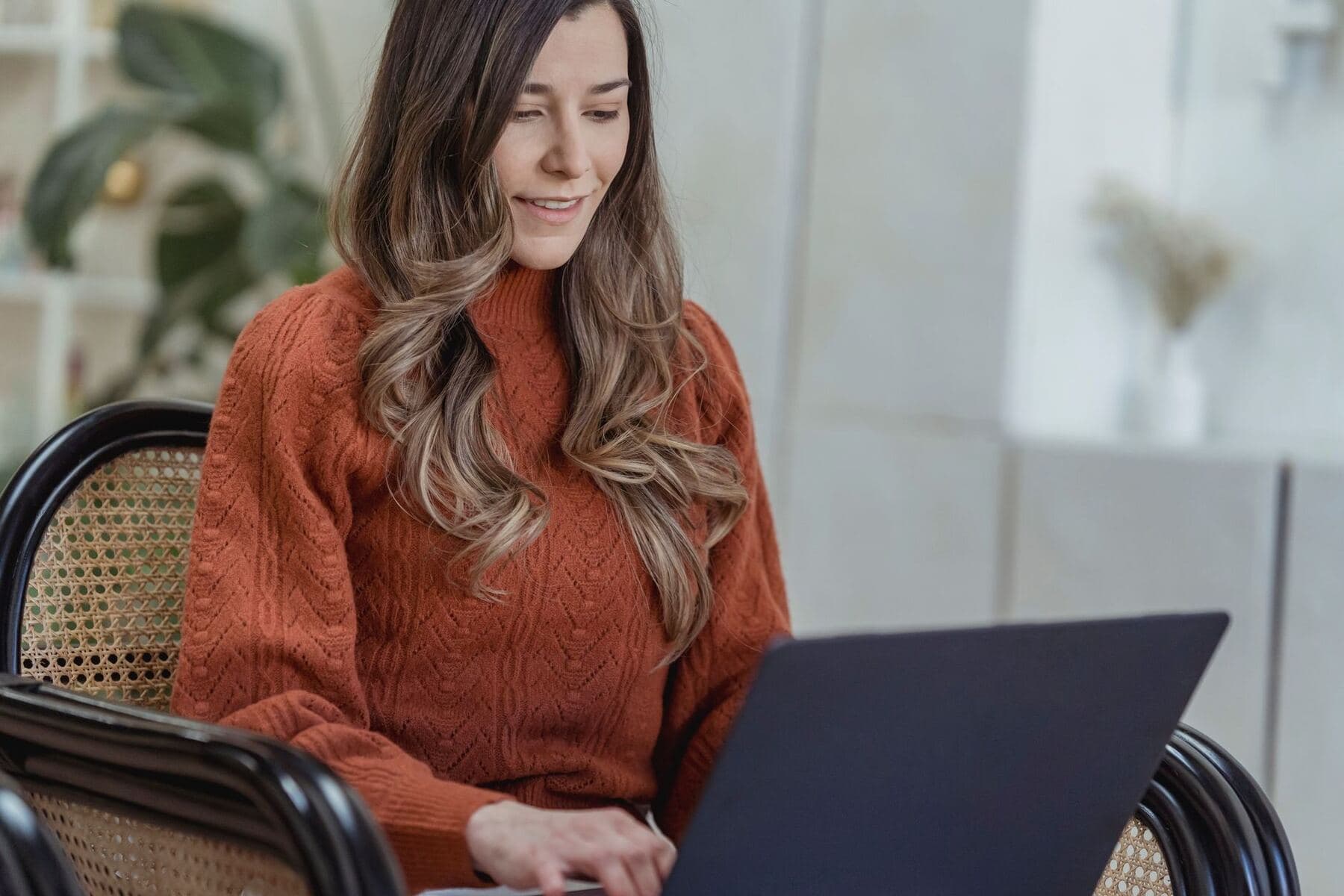 Woman scheduling posts on a laptop