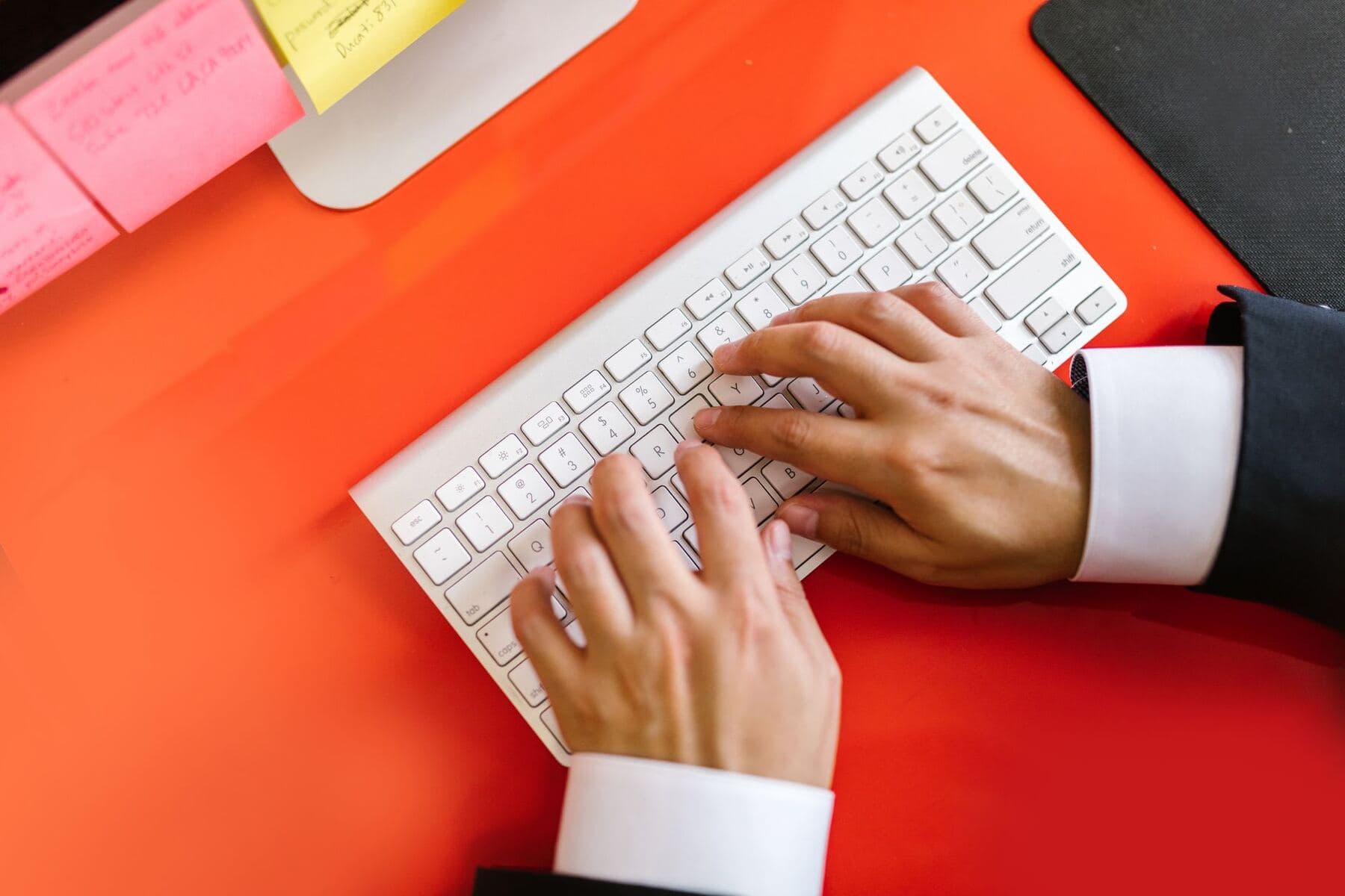 Hands typing on a keyboard while configuring a scheduler