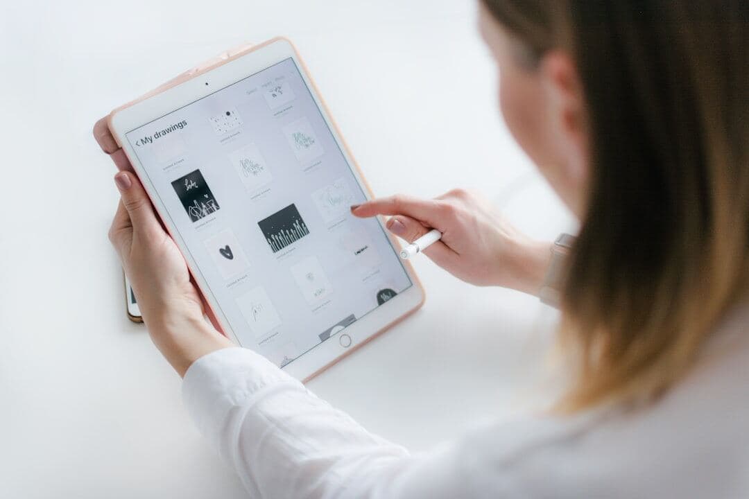 Person reviewing scheduled work on a tablet before it publishes