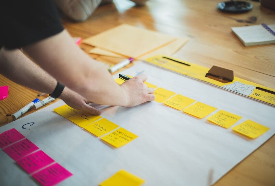 Person brainstorming niche ideas with sticky notes
