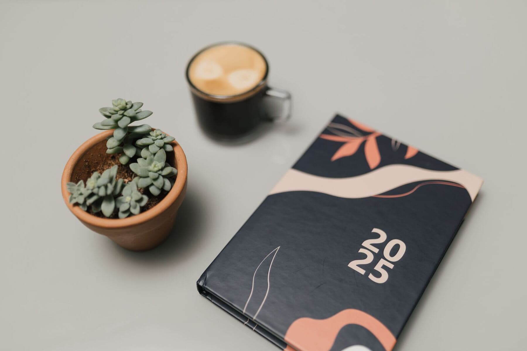 Planner and coffee on a desk